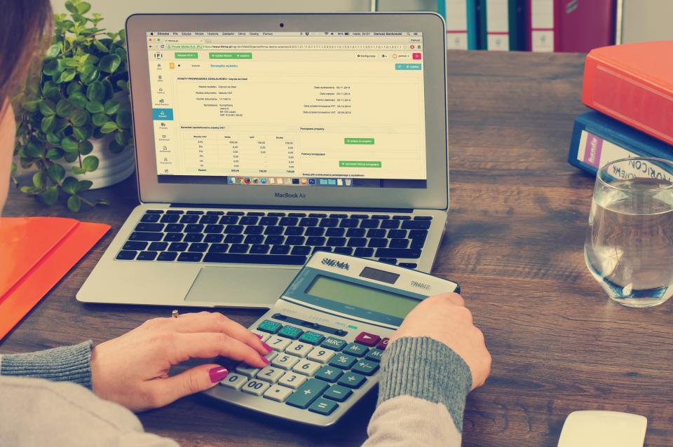 Working through accounts with a laptop and calculator